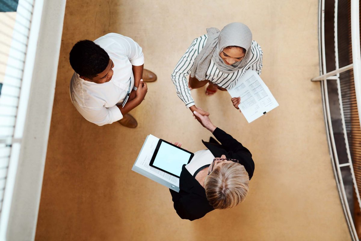 high-angle-shot-of-businesspeople-shaking-hands-in-EMJ3THD.jpg